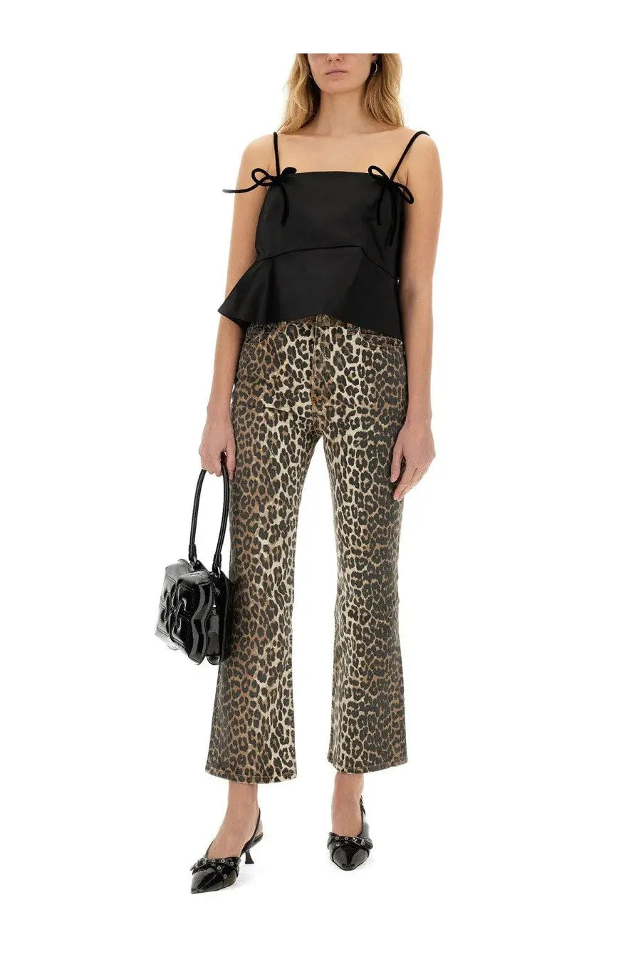 Black handbag with glossy finish and sculpted floral design complementing Ganni women’s jeans animalier pattern