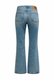 Back side of ganni women’s jeans betzy blue light-wash denim flare jeans with classic pocket and brown leather patch