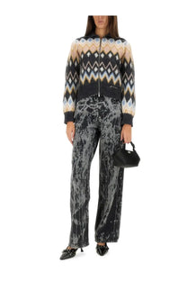 Black structured mini handbag with top handle and metallic hardware paired with Ganni women’s Izey multicolor jeans