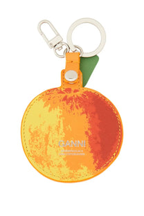 Ganni women’s keychain featuring a vibrant orange peel-patterned design with green leaf accent and silver hardware