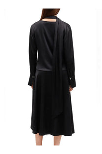 Black satin midi dress with long sleeves and draped back by ganni shown from the back side
