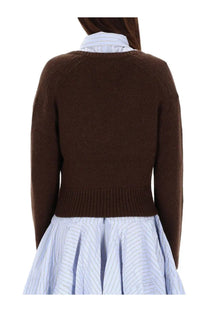 Ganni women’s neck sweater brown knitted with ribbed cuffs and hem worn over a light blue pinstriped shirt