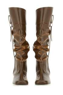 Ganni women’s black leather slouchy boots with ruched design and silver buckle accents