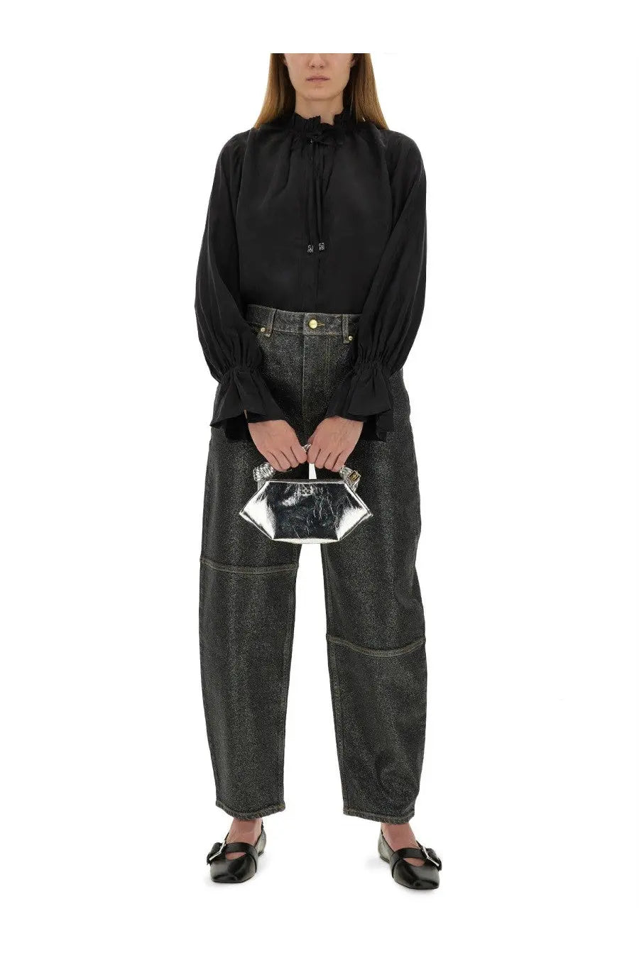 A sleek silver clutch with a reflective metallic finish and hexagonal shape paired with ganni womens stary jeans
