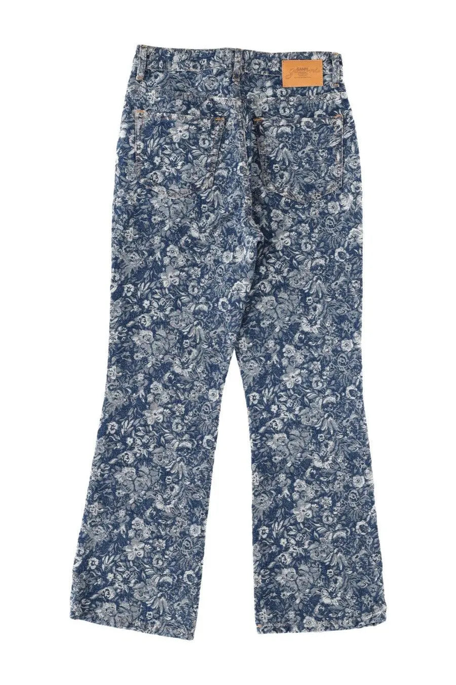 Ganni women’s tapestry blue denim jeans with a delicate white and gray floral pattern across the fabric