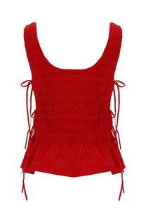 Ganni women’s red smocked sleeveless top with tied side strings and ruffled hem made from lightweight fabric