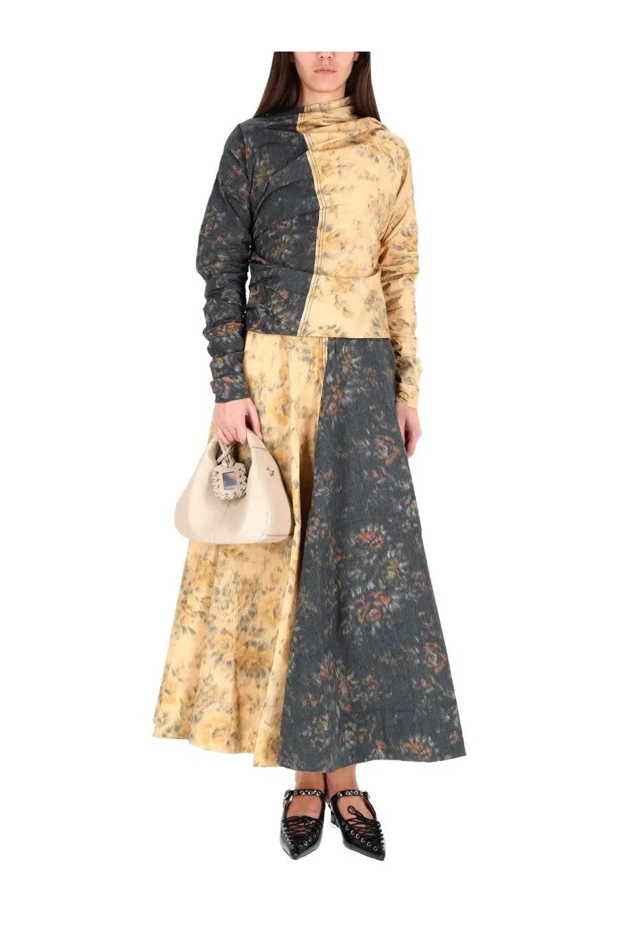 A beige handbag with a decorative embellished clasp complementing Ganni women’s multicolor tops