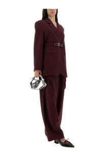 Silver metallic hexagonal handbag with textured surface and structured design paired with red ganni women’s twill pants