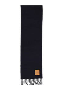 A sleek navy blue wool ganni women’s scarf with subtle texture fringed ends and a tan leather tag at the bottom