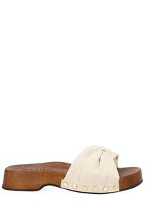 Cream-colored suede slide sandal ganni women’s zoccolo tia fairy white with wooden platform sole and gold-tone studs