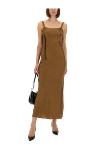 The garment women’s dress catania bronze is an olive green satin slip dress with thin straps and a front tie detail