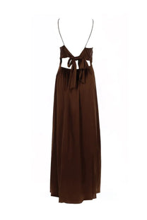 The garment women’s long dress cata brown is a flowing chocolate brown satin maxi dress with thin straps and a tied bow waist