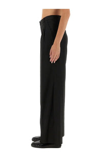 Black wide-leg trousers with sleek minimalist design and subtle pleats at the waistband from the garment womens pants pluto black