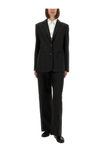 The Garment women’s Pluto blazer in black tailored fabric with notched lapels and two front buttons paired with wide-leg trousers