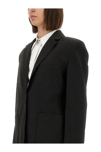 Black tailored blazer with structured silhouette and notched lapels from the garment women’s pluto blazer collection