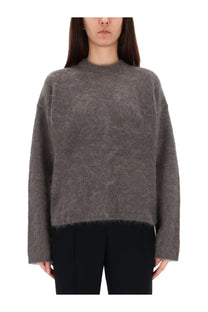 The garment women’s roma boyfriend sweater grey is a soft textured knit with a subtle pattern and frayed hem