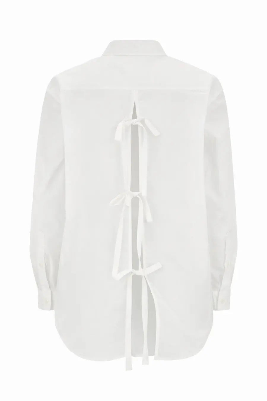 The back side of a minimalist white cotton blouse with a distinctive back tie detail from the garment womens shirt cyprus white