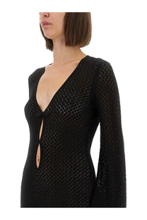 The garment women’s short black knit dress features long sleeves a deep v-neck and a delicate bow at the center front