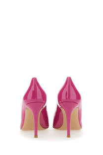 Vibrant fuchsia patent leather high-heeled pumps with pointed toe and gold-tipped stiletto heels by Gianvito Rossi
