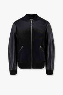 Givenchy men’s black cotton and nylon bomber jacket with silver zipper and ribbed cuffs visible from the front