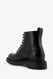 Givenchy men’s black leather ankle combat boot with chunky rubber sole and visible stitching details
