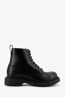 Black givenchy men’s leather ankle combat boot with glossy finish and chunky rubber sole