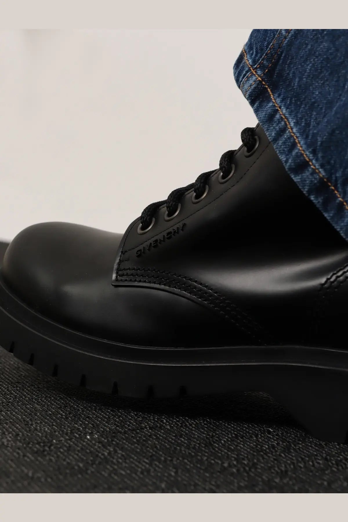 Givenchy men’s black leather combat boot with glossy upper and thick rubber sole for durable wear