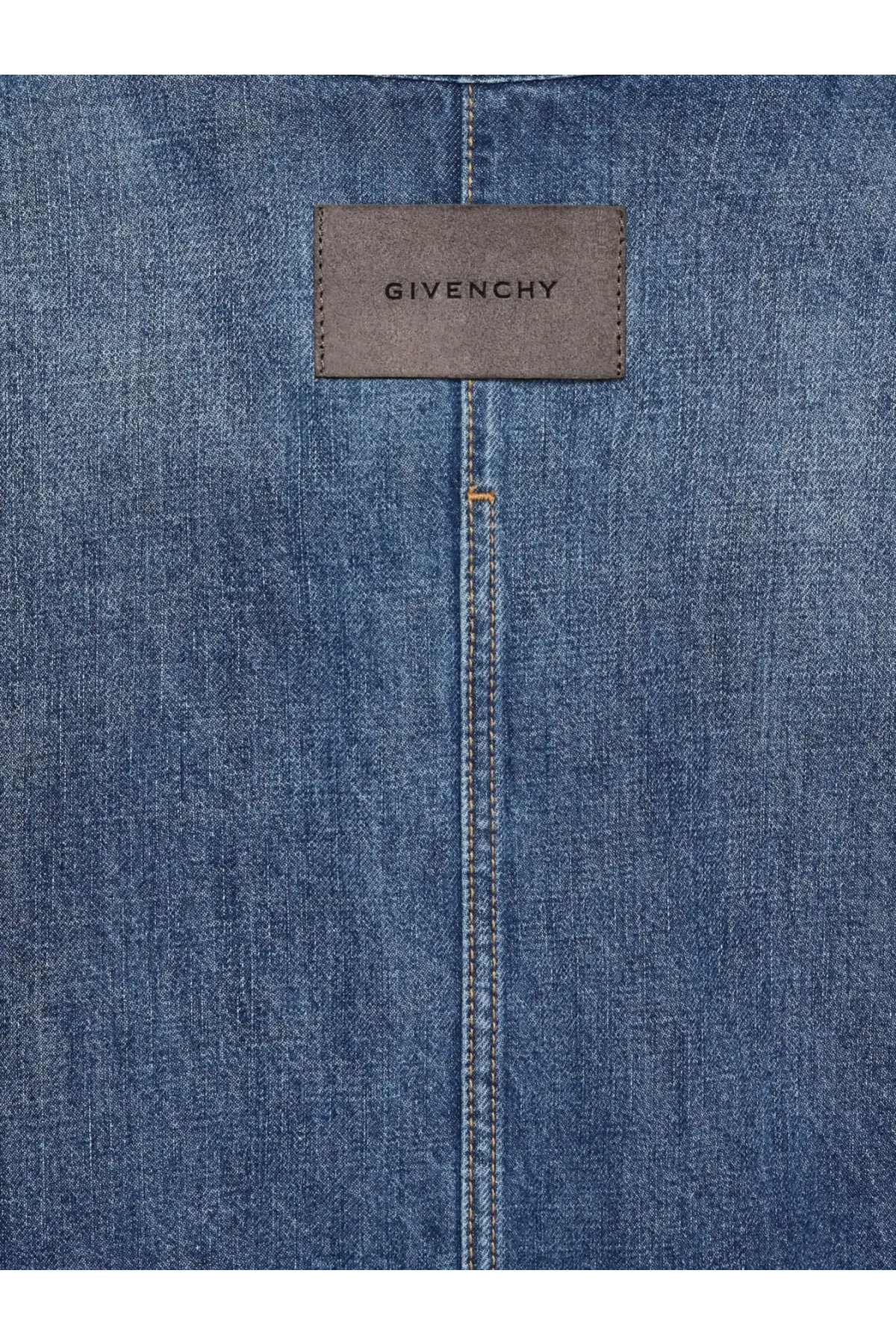 A brown leather givenchy label stitched on medium-wash blue denim fabric of givenchy mens overshirt denim shirt