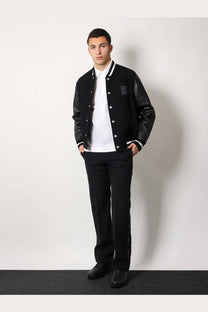 Givenchy men’s black leather and fabric varsity jacket with white trim and silver buttons