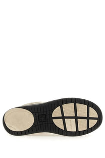 Back view of givenchy men’s skate sneaker white featuring black and beige rubber sole with geometric pattern and logo embossing
