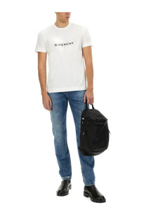 Black givenchy backpack with sleek minimalist design and subtle branding paired with givenchy men’s slim fit blue denim jeans
