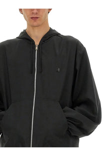 Givenchy men’s black hooded zip sweatshirt with silver zipper and small logo patch on chest