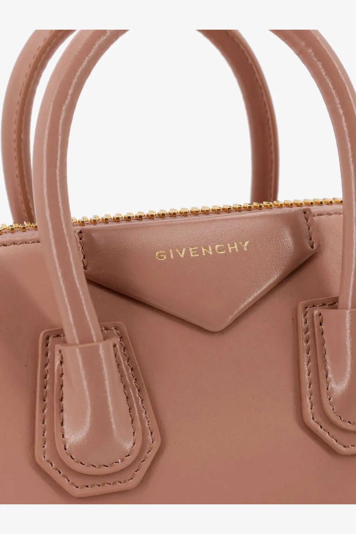 Beige Givenchy women’s Antigona mini leather crossbody bag with gold-tone hardware and structured leather handles