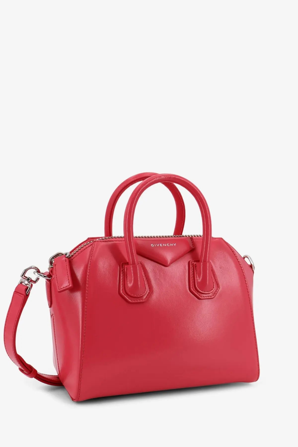 A vibrant red Givenchy women’s antigona mini leather crossbody bag with structured body and matching handles