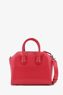 Vibrant red Givenchy Antigona mini leather crossbody bag with structured silhouette and glossy finish