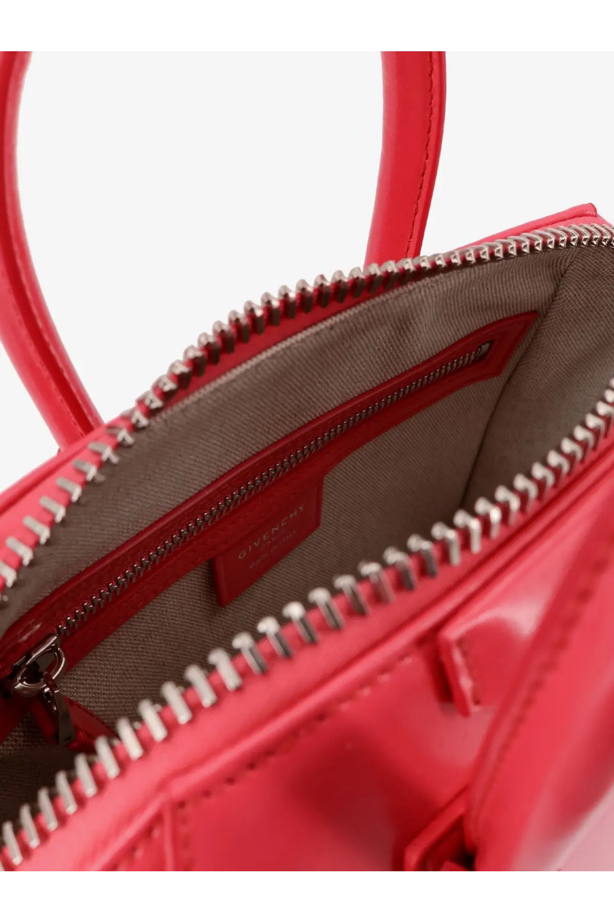 Vibrant red patent leather Givenchy Antigona Mini crossbody bag with silver-toned zipper and structured handles
