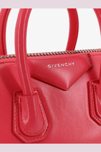 Vibrant red Givenchy Antigona mini leather crossbody bag with structured body and signature triangular flap