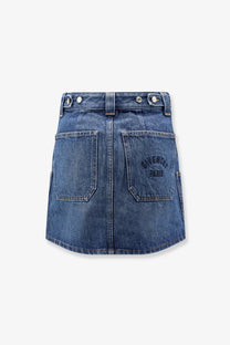 Back view of givenchy women’s blue denim mini skirt with two pockets and dark embroidered givenchy paris logo