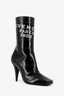 Givenchy women’s black patent leather ankle boot with high stiletto heel and white givenchy paris 1952 lettering on shaft