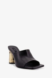 Givenchy women’s black leather mule sandal with a gold-tone embossed block heel visible from the back side
