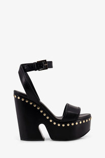 Givenchy women’s black leather platform sandal with gold-tone studs and ankle strap buckle shown from the back side