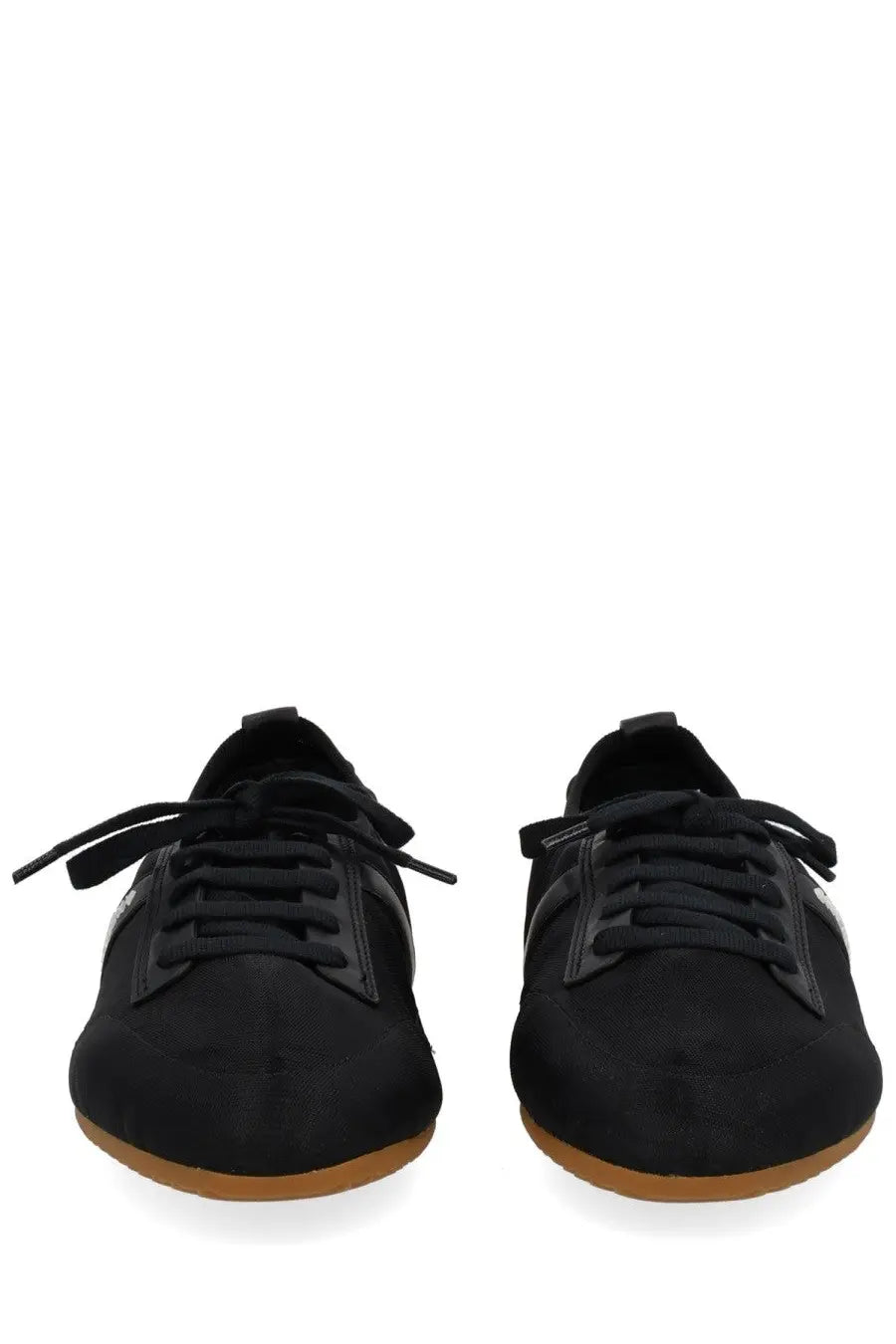 Givenchy women’s minimal slim sneaker in black suede with black leather accents and tan rubber sole shown from back side