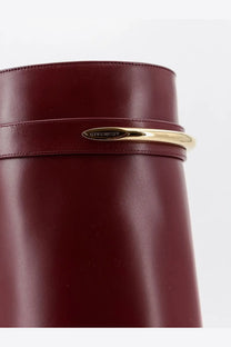 A sleek burgundy leather Givenchy bag with polished gold-tone metal clasp perfect for stylish outings
