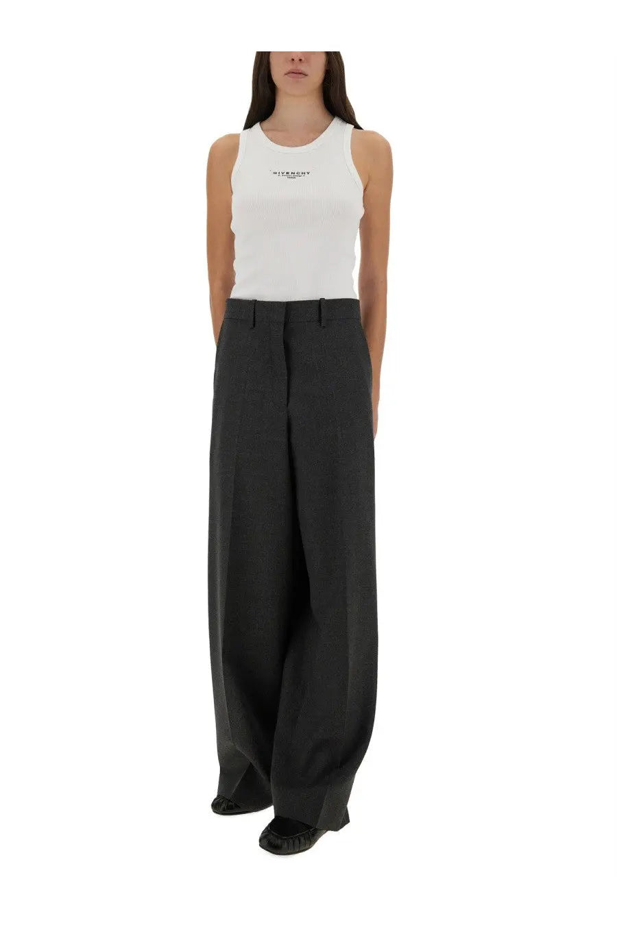 Black wide-leg trousers with tailored fit and subtle creases paired with Givenchy women’s slim white tank top
