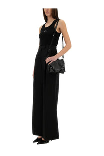 Black leather crossbody bag with silver hardware and minimalist design pictured with Givenchy women’s black tank top