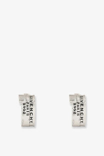 Silver Givenchy Paris 1952 huggie earrings with a textured slightly distressed finish in metal and enamel silver