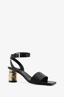 Givenchy women’s black leather sandal with gold embossed textured block heel and ankle strap front view
