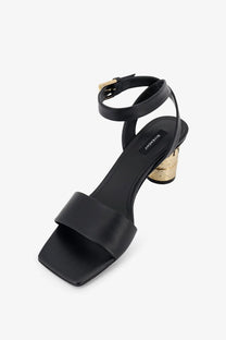 Givenchy women’s tape black leather heeled sandal with gold-toned block heel and ankle strap, front view