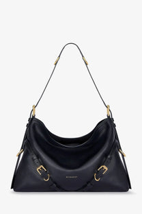 Black Givenchy women’s Voyou medium leather shoulder bag with gold-tone hardware and structured slouchy silhouette