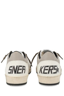 Back side of golden goose men’s ballstar sneaker in white and gray suede with black sneakers lettering on heel
